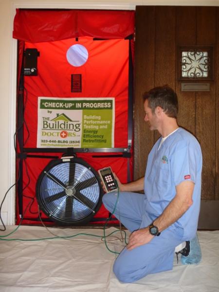 An energy doctor performing a blower door test