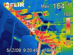 Thermal image of un-insulated hot water pipes leaching heat into a house